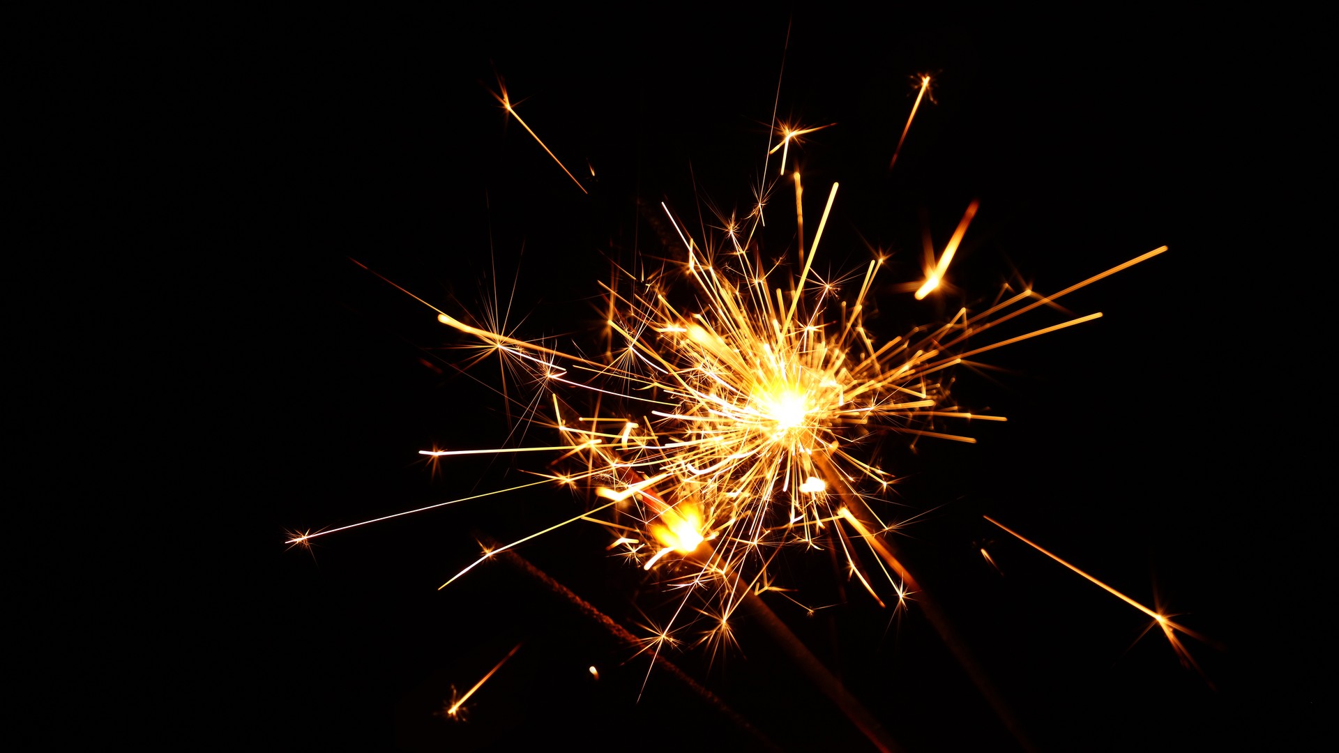 Close up several firework sparklers over black